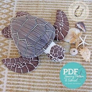 May include: A plush turtle toy with a brown and white shell and flippers, surrounded by seashells and a starfish. The turtle has a geometric pattern on its shell. A teal circle with white text reads "PDF Sewing Pattern & Tutorial by Rustic Horseshoe."