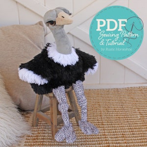 May include: A plush ostrich toy sitting on a wooden stool. The ostrich is black and white with a long neck and legs. The toy is part of a PDF sewing pattern and tutorial by Rustic Horseshoe.