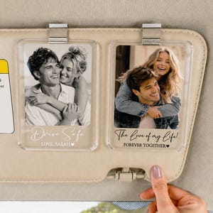May include: Two rectangular clear acrylic car visor clips featuring black and white photographs of a couple. The left clip displays the text Drive Safe and LOVE, SARAH. The right clip displays the text The love of my life! FOREVER TOGETHER.