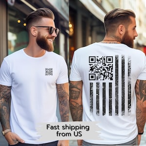 May include: White t-shirt with a black and white QR code on the front and a black and white distressed American flag on the back.