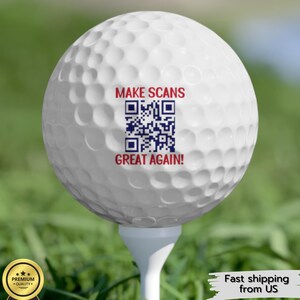 May include: A white golf ball with a red and blue design that says "MAKE SCANS GREAT AGAIN!" and a black and white QR code.
