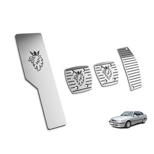 May include: Set of four silver-colored car pedal covers. The covers feature a stylized eagle emblem and are designed for a car. A silver car is shown in the background.
