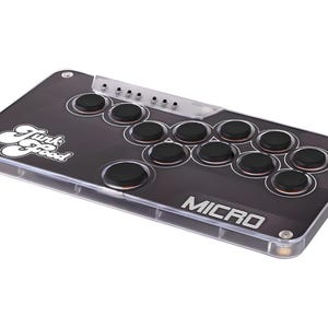 Puede incluir: Un mando de arcade negro con una carcasa de plástico transparente. Tiene 16 botones y el texto "Funk Good" y "MICRO" impreso en la parte delantera.