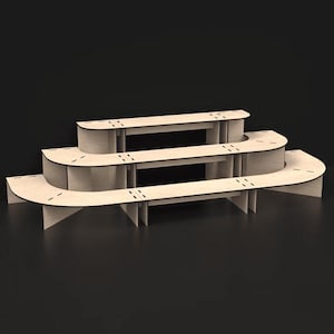 May include: A three-tiered display stand made of light-colored wood. The stand has a curved design with a black trim and is suitable for showcasing products. The stand is constructed with multiple horizontal shelves and supporting legs.