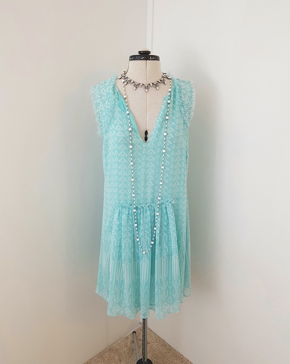 aqua beach dress, muff at front, waterfall appliqu
