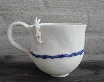 Mug in white porcelain with rabbit looking over the rim - handmade ceramic whimsical mug