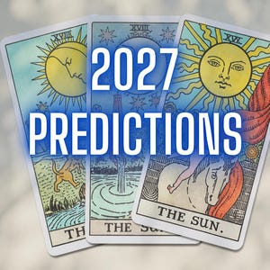 May include: Three tarot cards with the text "2027 PREDICTIONS" in white. The cards feature illustrations of the sun, a horse, and other symbolic imagery. The cards have a light blue border and are set against a blurred background.