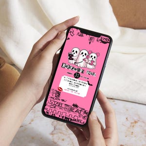 May include: A smartphone displaying a pink Halloween-themed graphic. The graphic features three cartoon ghosts and the text "Halloween Party". Additional text includes event details and decorative elements in black.