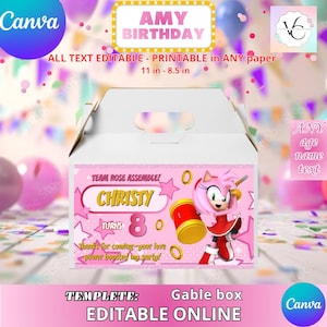 May include: A white gable box with a pink and gold design, featuring the text "AMY BIRTHDAY" and "CHRISTY TURNS 8". The box includes a cartoon character and the words "EDITABLE ONLINE". The box is 11 inches by 8.5 inches.