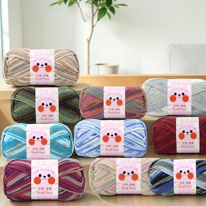 May include: A collection of colorful yarn skeins, each wrapped with a label featuring a cartoon bunny face and the text "Yank-love". The yarn colors include shades of blue, green, red, and neutral tones, suitable for various knitting and crochet projects.