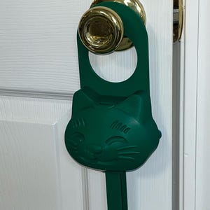 A dark green (mistletoe) Sidewinder smart cat toy.