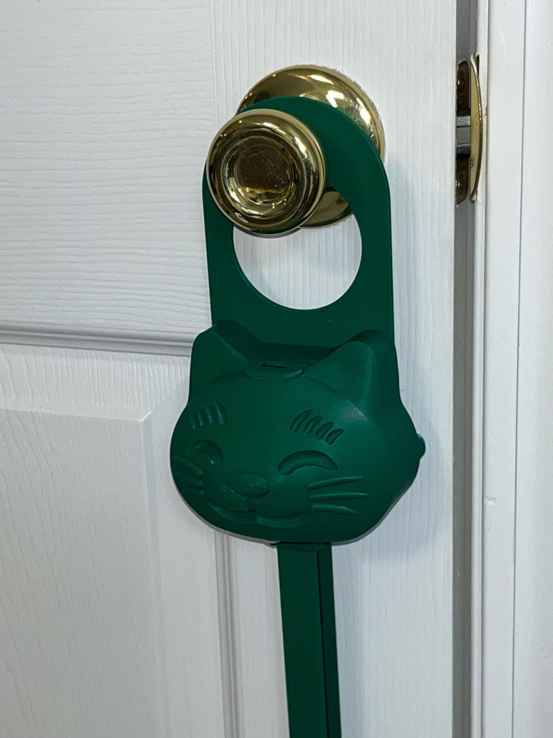 A dark green (mistletoe) Sidewinder smart cat toy.