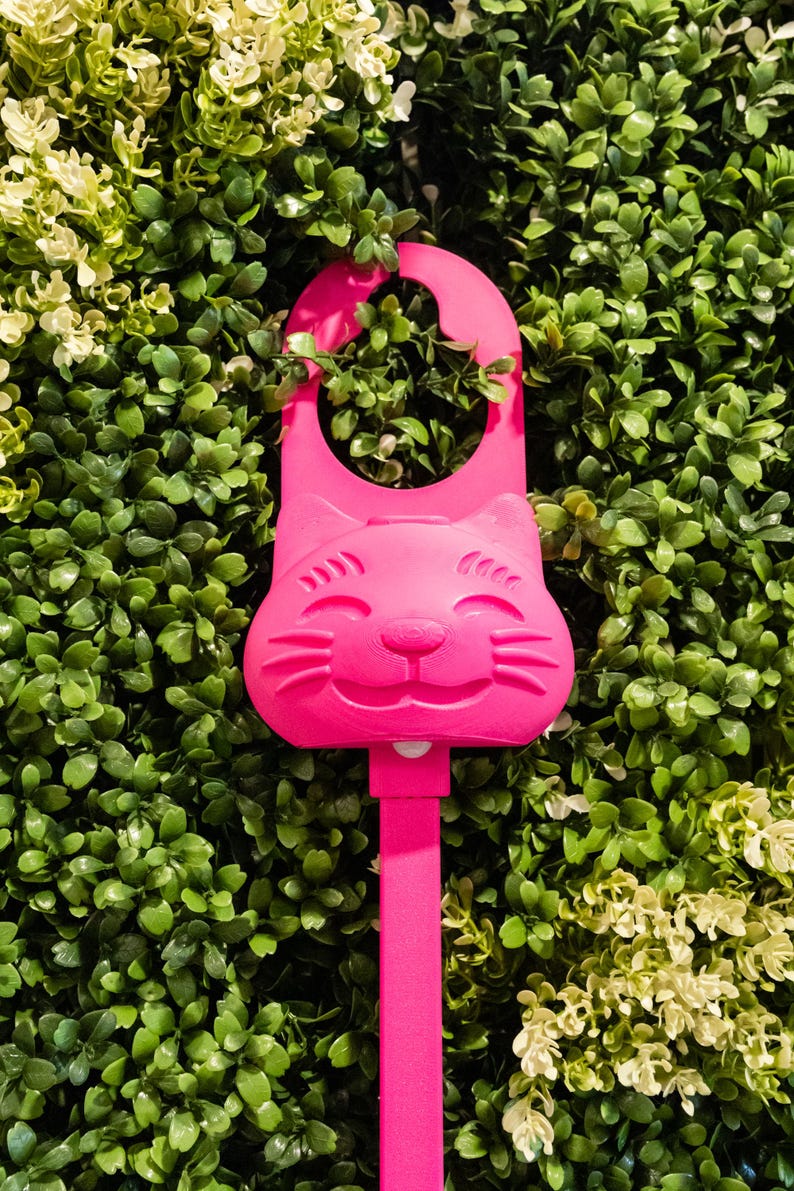 A magenta/pink Sidewinder smart cat toy.