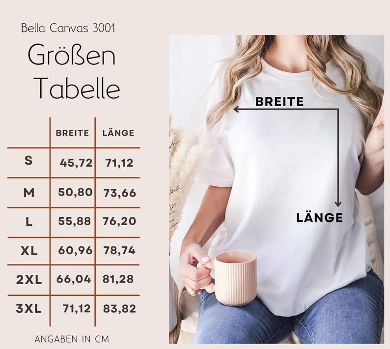 May include: A white Bella Canvas 3001 t-shirt with a size chart in centimeters. The chart shows measurements for width and length, ranging from size S to 3XL. The person is holding a peach-colored mug.