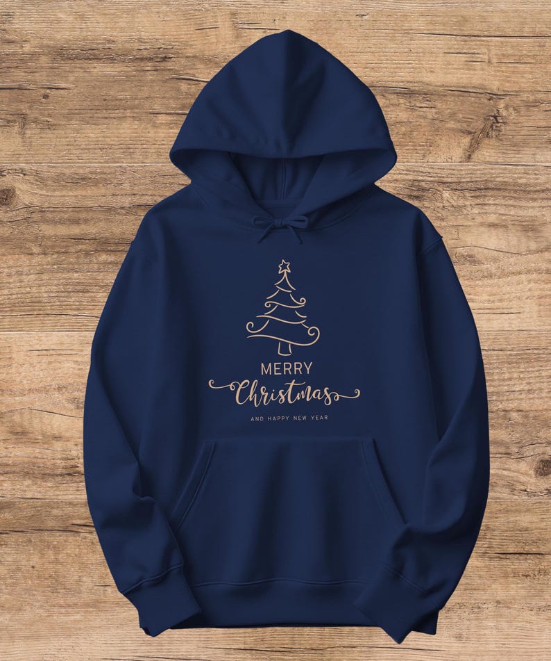 May include: Navy blue hooded sweatshirt with a front pocket and drawstring. The sweatshirt features a gold-colored Christmas tree design with the words "MERRY Christmas" and "AND HAPPY NEW YEAR" printed below the tree.