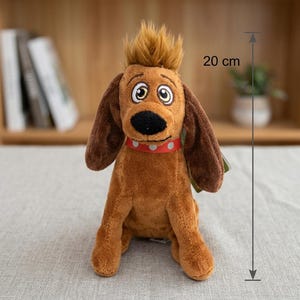 May include: A brown plush dog toy with long ears, a tuft of hair on its head, and a red collar with white dots. The toy features large, expressive eyes and a black nose. A measurement indicator shows the plush toy is 20 cm in total height.