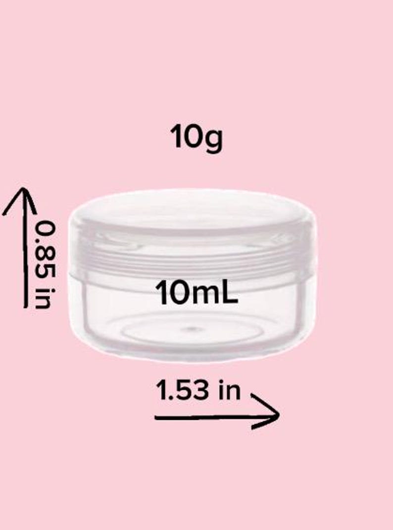 May include: A clear, round, empty plastic cosmetic jar with a screw-top lid. The jar is labeled with a capacity of 10g and 10mL. Dimensions indicated are 0.85 inches in height and 1.53 inches in diameter, shown with black arrows and text.