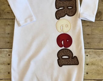 Name appliqued in sock monkey fabrics baby gown with or without an embroidered beenie cap.