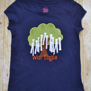 Navy shirt has a rolled oak tree appliqué.