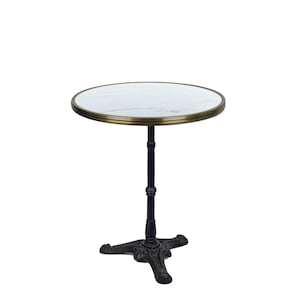 May include: A round bistro table with a white marble top and a brass-colored trim. The table has a black, ornate cast iron base and a central support. The table is approximately 28 inches in diameter.