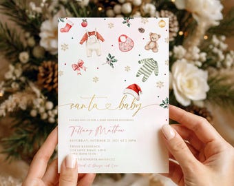 May include: A baby shower invitation with a festive Christmas theme. The card features watercolor illustrations of baby clothes, a teddy bear, and a Santa hat. The text reads "Santa Baby" in elegant script, with event details below.