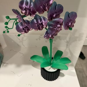 May include: A set of three ceramic mugs with a speckled, matte finish. The mugs are in shades of cream, light gray, and dark gray. Each mug has a simple, minimalist design, perfect for coffee or tea.