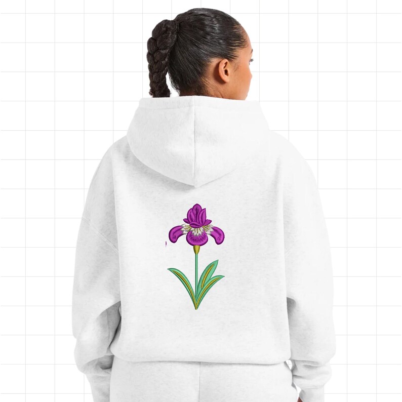 May include: A white hoodie with a purple iris flower design on the back. The flower has purple petals with white accents, green leaves, and a green stem. The hoodie is made of a soft, comfortable material.