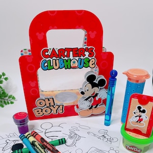 May include: A red gift bag with "CARTER'S CLUBHOUSE" text and a Mickey Mouse cutout. Includes coloring pages, crayons, Play-Doh, and bubbles. The coloring pages feature Mickey Mouse and friends. A fun party favor set.