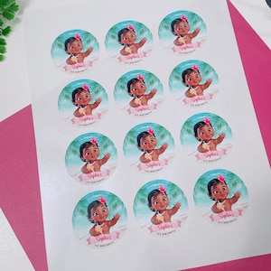 May include: Sheet of round stickers featuring a cartoon baby girl with a flower in her hair, waving in front of a tropical beach scene. The stickers say "Sophia's 1st Birthday" and "Thanks for Coming".