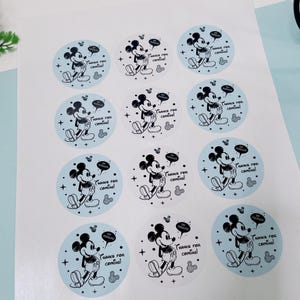 May include: Sheet of round stickers featuring Mickey Mouse in a classic pose. Each sticker has a light blue or white background with the text "Thanks for coming!" and "Tooodles". The stickers have a cartoon style.