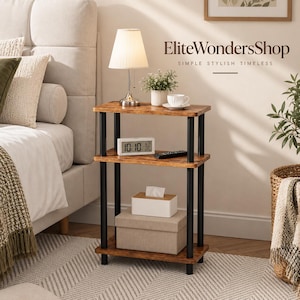 May include: A three-tier side table with a brown wood-grain finish and black metal support poles. The top shelf holds a white lamp, a small potted plant, and a white teacup. The middle shelf holds a digital clock and remote. A tissue box sits below.