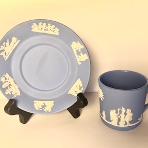 May include: A blue and white teacup and saucer set with a white floral design. The set is made of fine bone china and is in excellent condition.