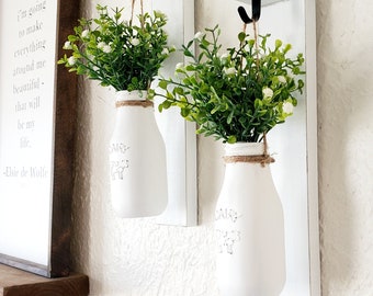 New. 2 Country Farmhouse Hanging Kitchen Wall Sconces.  Painted Dairy Cow Milk Bottles.Flowering Greenery. Distressed White Wood Wall Decor