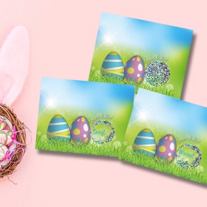May include: Three Easter-themed cards with a blue and green background. Each card features two colorful Easter eggs and a glitter-filled egg with the text "Scratch & Win!" and a different word inside the glitter egg. The words are "Sorry!" "Winner!" and "Song!"