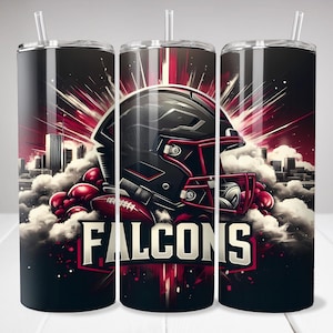 May include: A black and red stainless steel tumbler with a football helmet graphic and the word "FALCONS" in white lettering. The background features a cityscape and clouds.