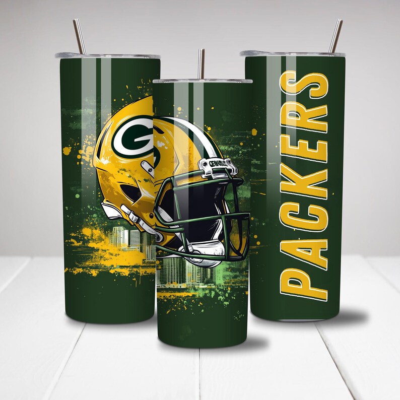 May include: Three green and yellow insulated tumblers with a football theme. One tumbler features a yellow football helmet with a green "G" logo. The other tumbler has the word "PACKERS" in yellow. Each tumbler has a straw.