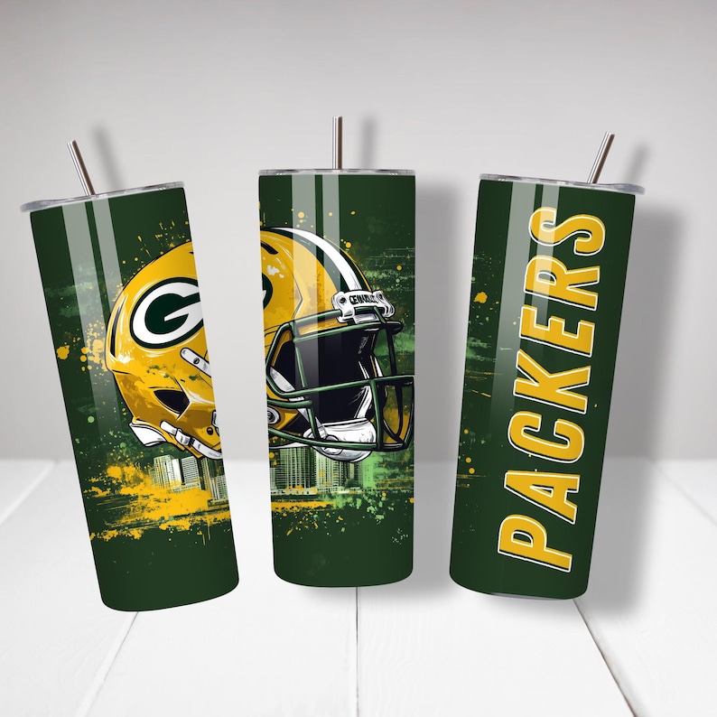 May include: Three green and yellow insulated tumblers with the Green Bay Packers logo and helmet design. Each tumbler has a silver lid and a straw. The Packers logo and helmet are in yellow and green.