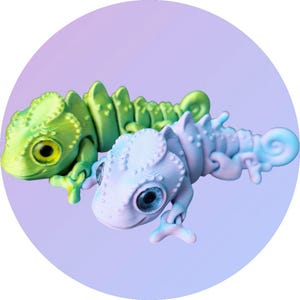 May include: Two small, plastic chameleon figurines. One is green and the other is light blue. Both have large, round eyes and detailed scales.