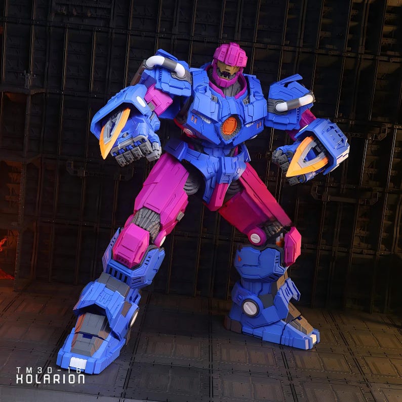 May include: A detailed action figure of a robot, predominantly blue and magenta. The figure has a complex design with angular features and an orange circular detail on its chest. The robot is posed in a dynamic stance, suggesting action.