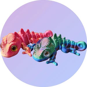 May include: Two chameleon figurines, one pink and one iridescent green, with detailed scales and textured surfaces.