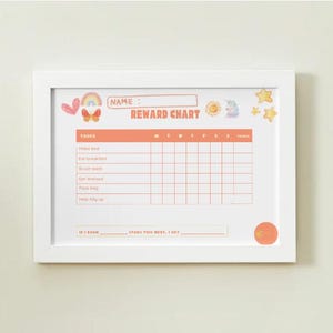 May include: A framed reward chart with a white border. The chart has an orange header and grid, with tasks listed below. Decorative elements include a rainbow, butterfly, sun, unicorn, and stars. The chart is designed for tracking progress.