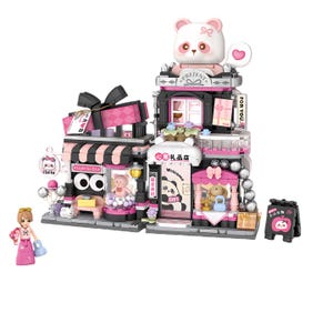 May include: A pink and black building block set featuring a gift shop theme. The set includes a panda bear figure, a sign that says "Hello", and the text "Light Go On". The set also includes a small figure of a person.