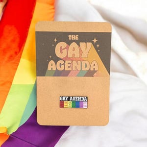 Agenda gay avec épingle à épingles - Broche à épingles en émail montée sur carton marron - emballée dans un sac cadeau en cellophane