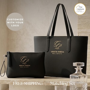May include: A black tote bag and a matching black zippered pouch, both featuring a gold monogram logo and the text Gracie Pineda Real Estate. The set includes long shoulder straps on the tote and a wrist strap on the pouch, with a textured finish.