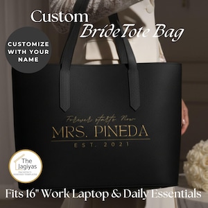 May include: Black tote bag with the text "Bride Tote Bag" and "Forever starts Now MRS. PINEDA EST. 2021" in gold lettering. The bag is designed to fit a 16-inch laptop and daily essentials. The bag has black handles.