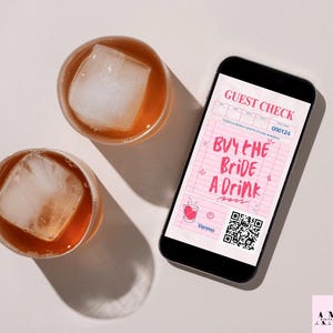 May include: Two glasses with ice cubes and amber liquid sit next to a smartphone. The phone displays a pink "Guest Check" with "Buy the Bride a Drink" in pink text, a QR code, and a Venmo logo.