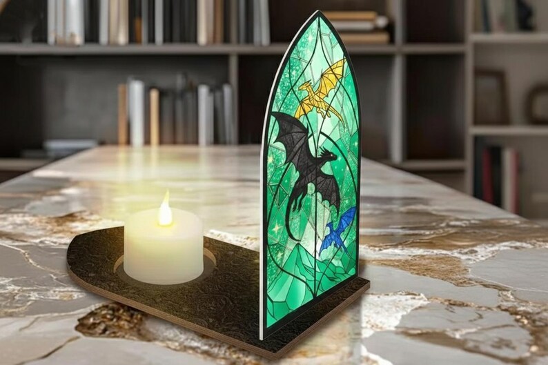 May include: A decorative stained glass panel with a dragon design in green, black, gold, and blue. A white candle sits in a dark brown holder. The panel is shaped like a church window.