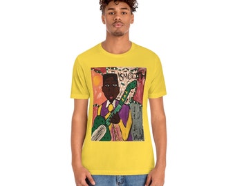 May include: A yellow t-shirt with a colorful illustration of a person playing a guitar. The illustration is surrounded by a white border and the word "SMOOCH" is visible in the top right corner.