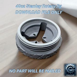 May include: A gray 3D printed rotary jig with a three-pronged design. The jig is 4 oz and is a Stanley brand. The text "DOWNLOAD FILE ONLY" is displayed above the jig. The text "NO PART WILL BE MAILED" is displayed below the jig.
