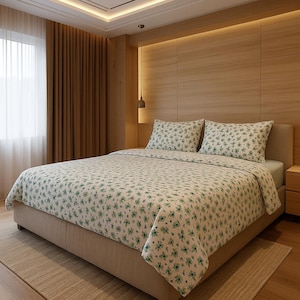 May include: A double bed with a floral patterned duvet cover and matching pillowcases. The bedding features a white background with a repeating pattern of small green flowers. The bed is in a room with wooden paneling.
